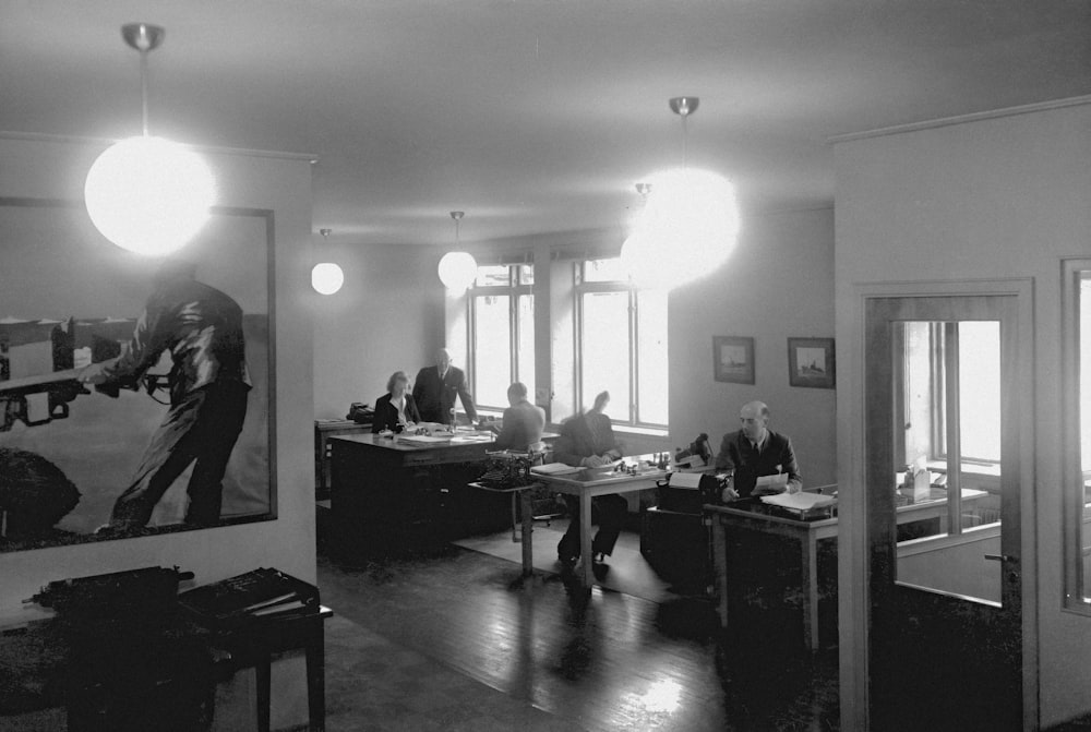 a black and white photo of people in a room