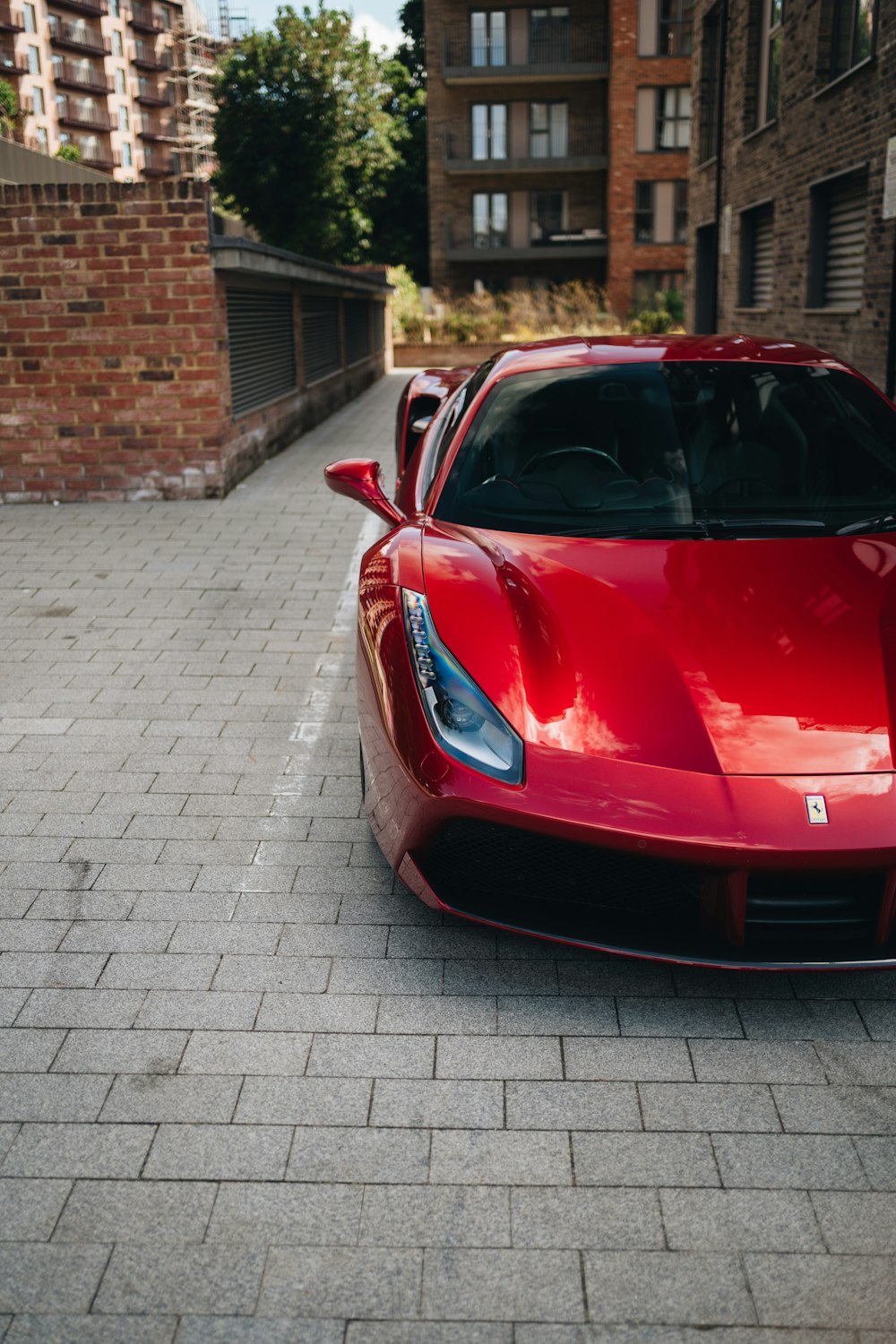 a red sports car parked on the side of a road