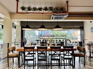 a restaurant with a large table and chairs