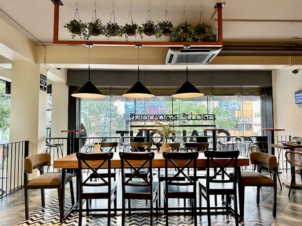 a restaurant with a large table and chairs