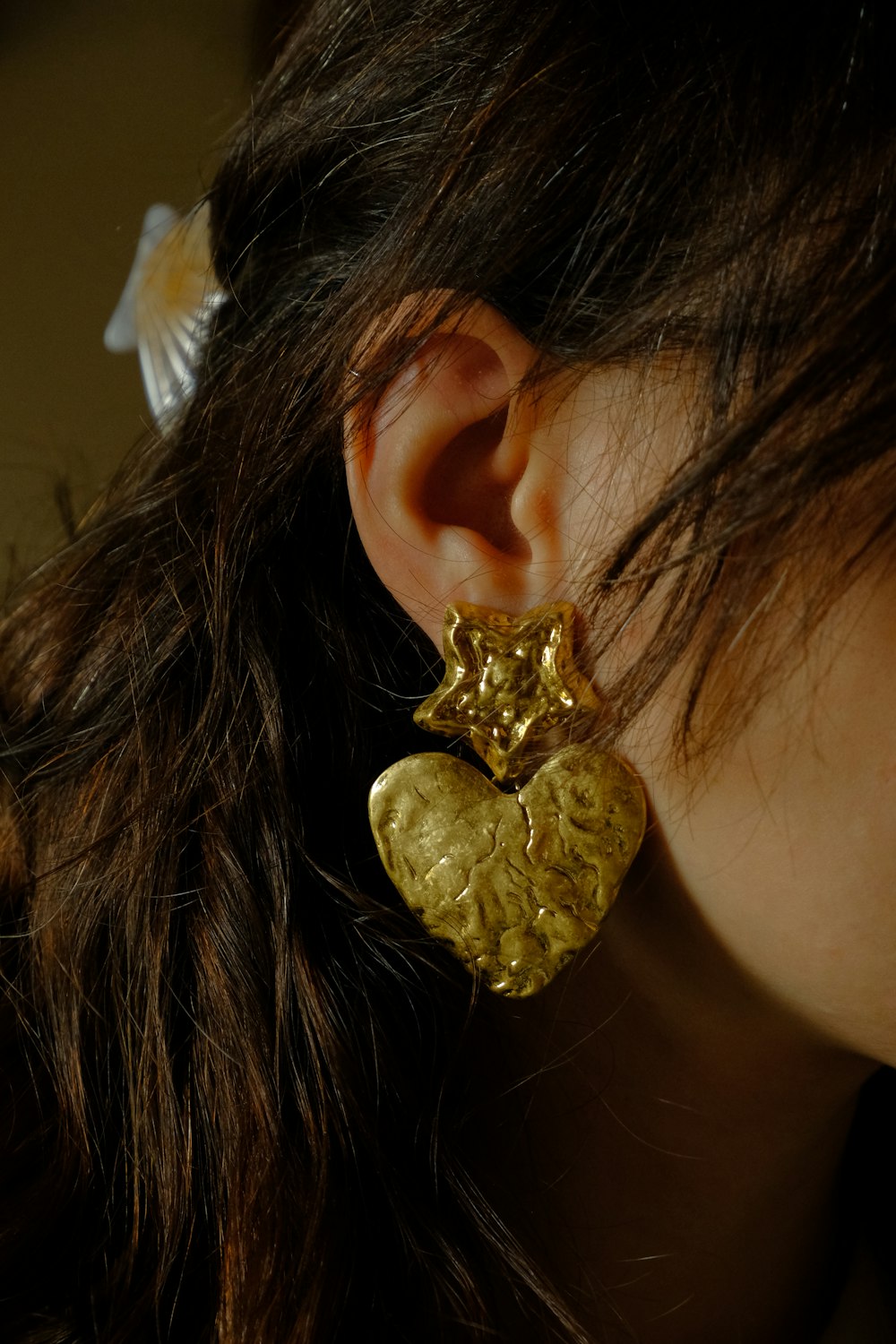 a close up of a person wearing a pair of earrings