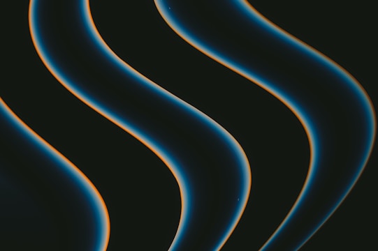 Abstract animated shapes and text flowing smoothly on a dark background.