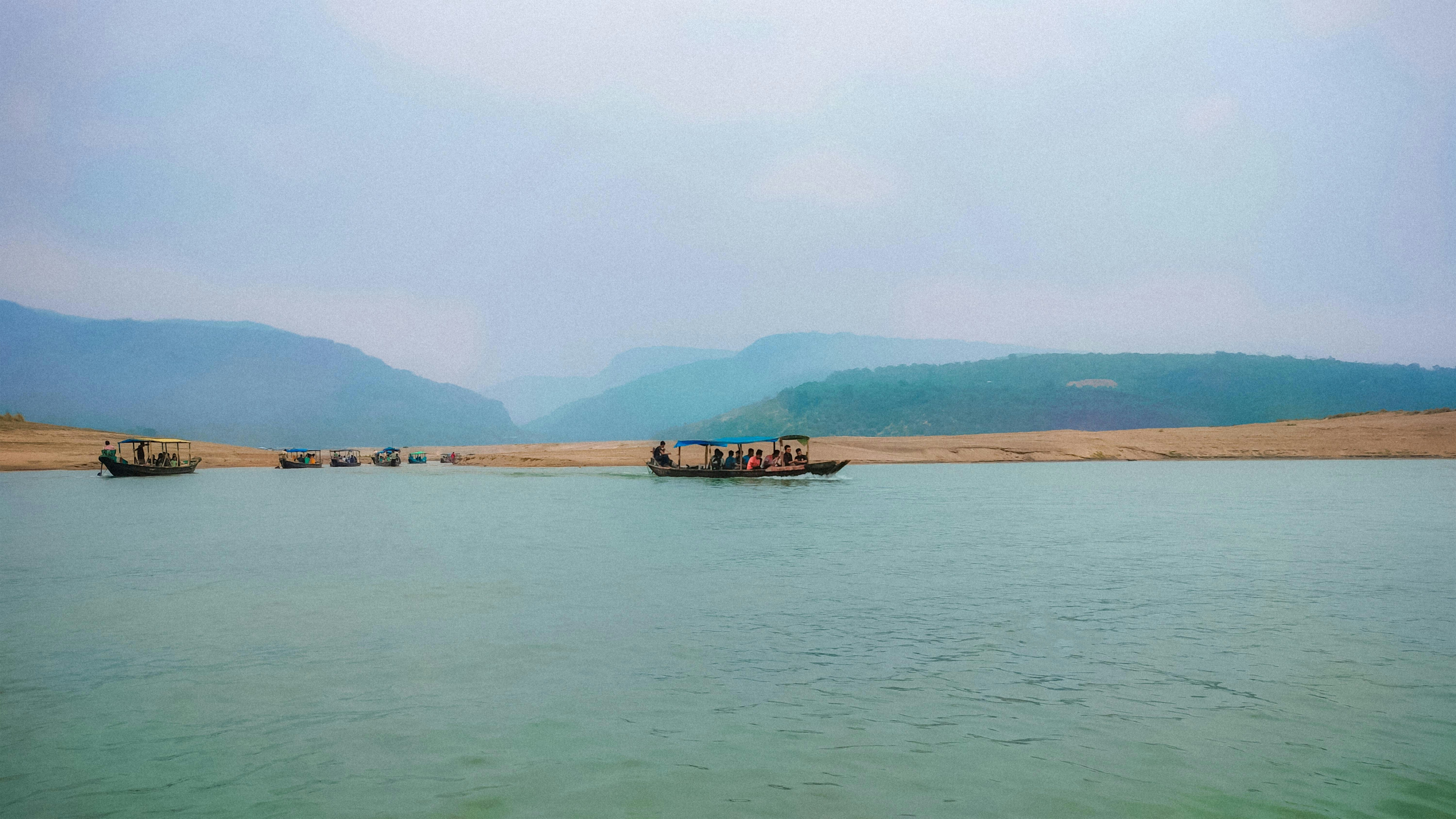 a group of boats floating on top of a lake