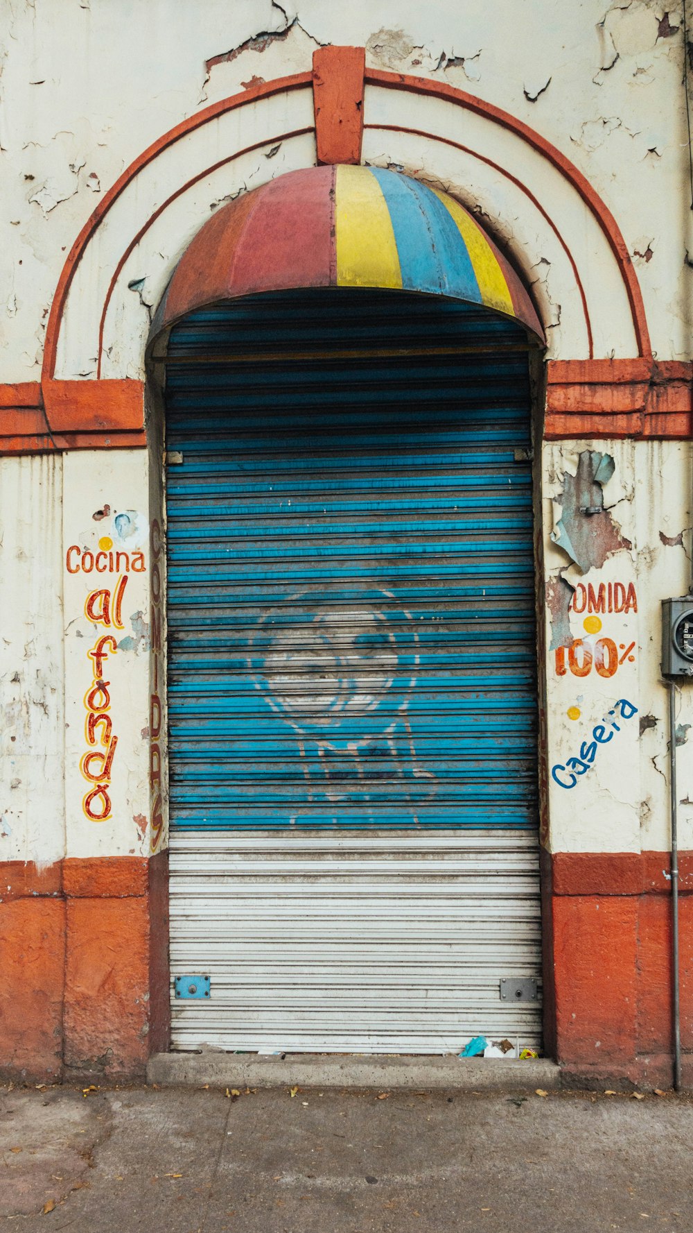 a closed garage door with graffiti on it