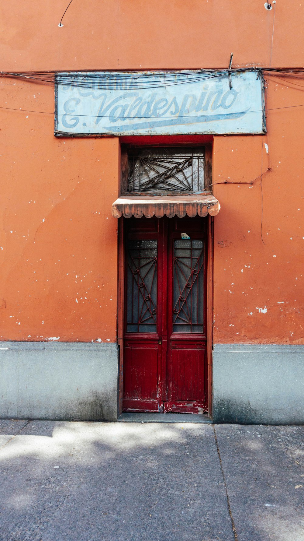 a red door with a sign above it