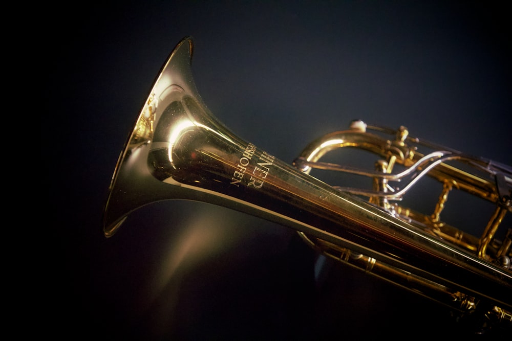 a close up of a brass trumpet on a black background