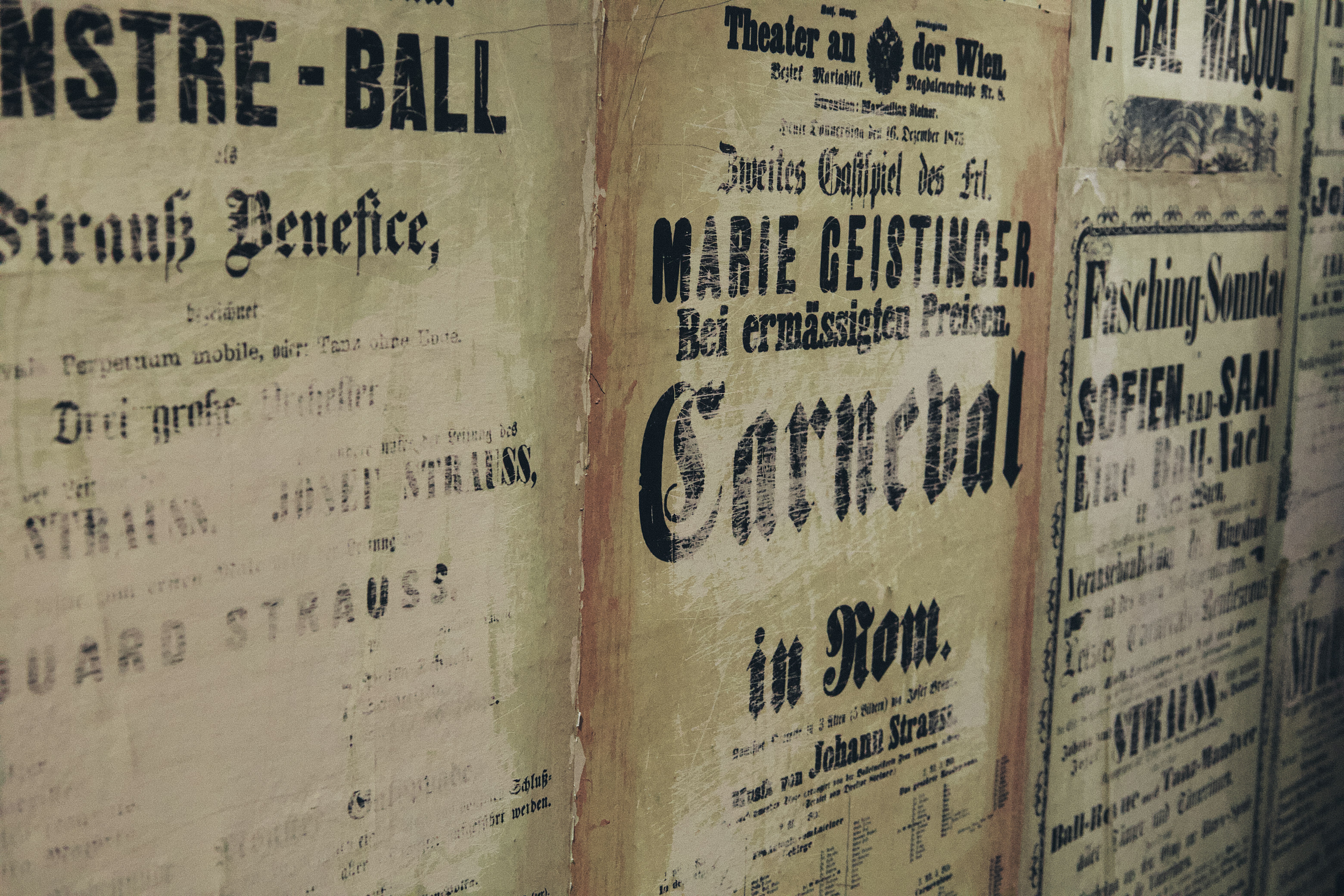a group of old newspapers are lined up on a wall
