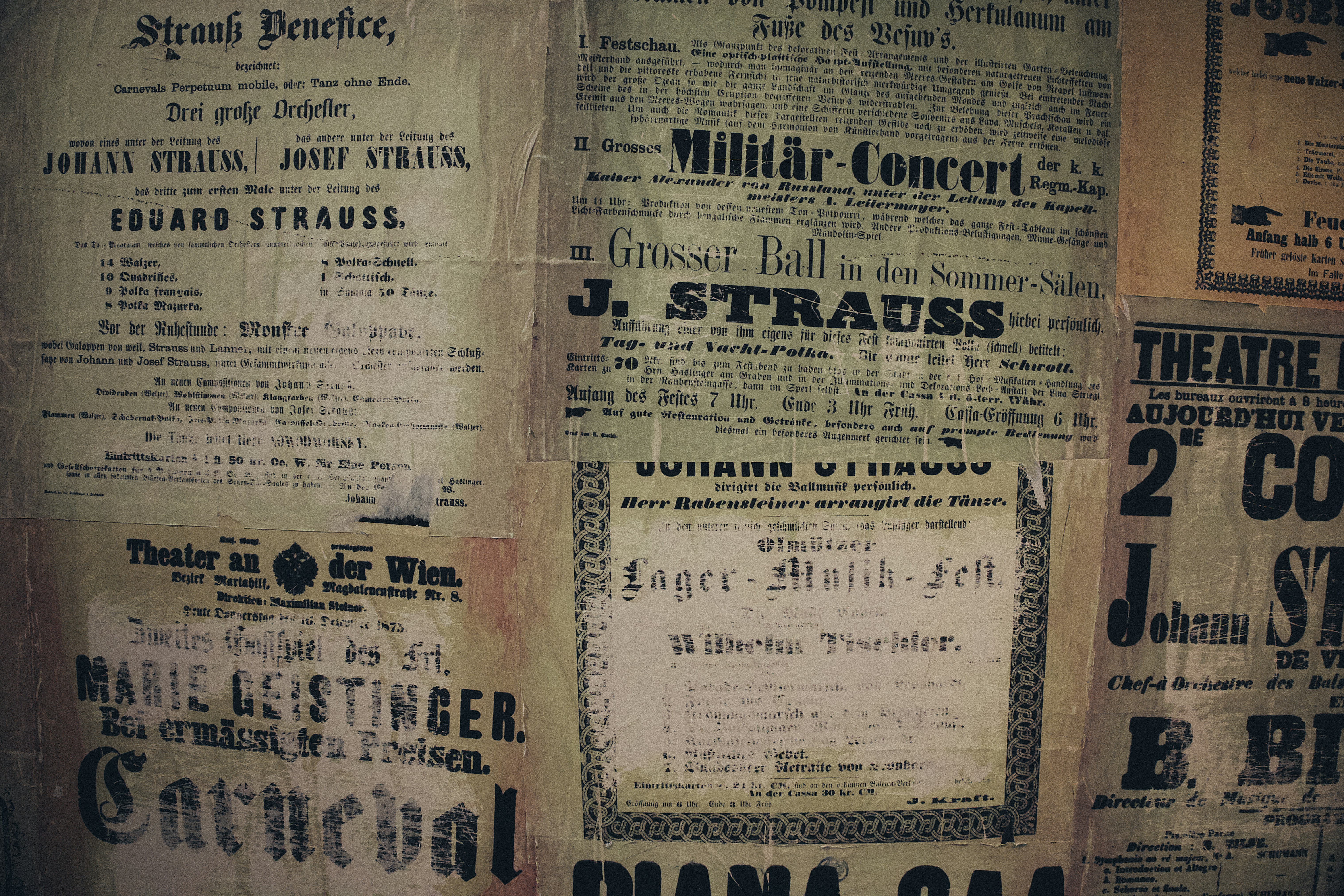 a wall covered in old newspaper with writing on it