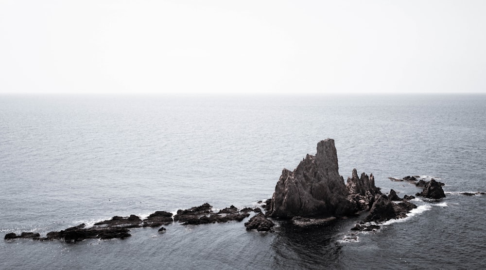 a rock outcropping in the middle of the ocean