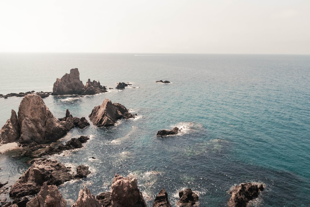 a body of water with rocks in the middle of it