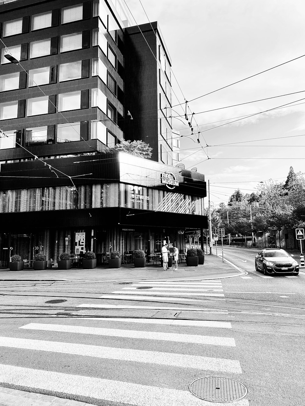 a black and white photo of a street corner