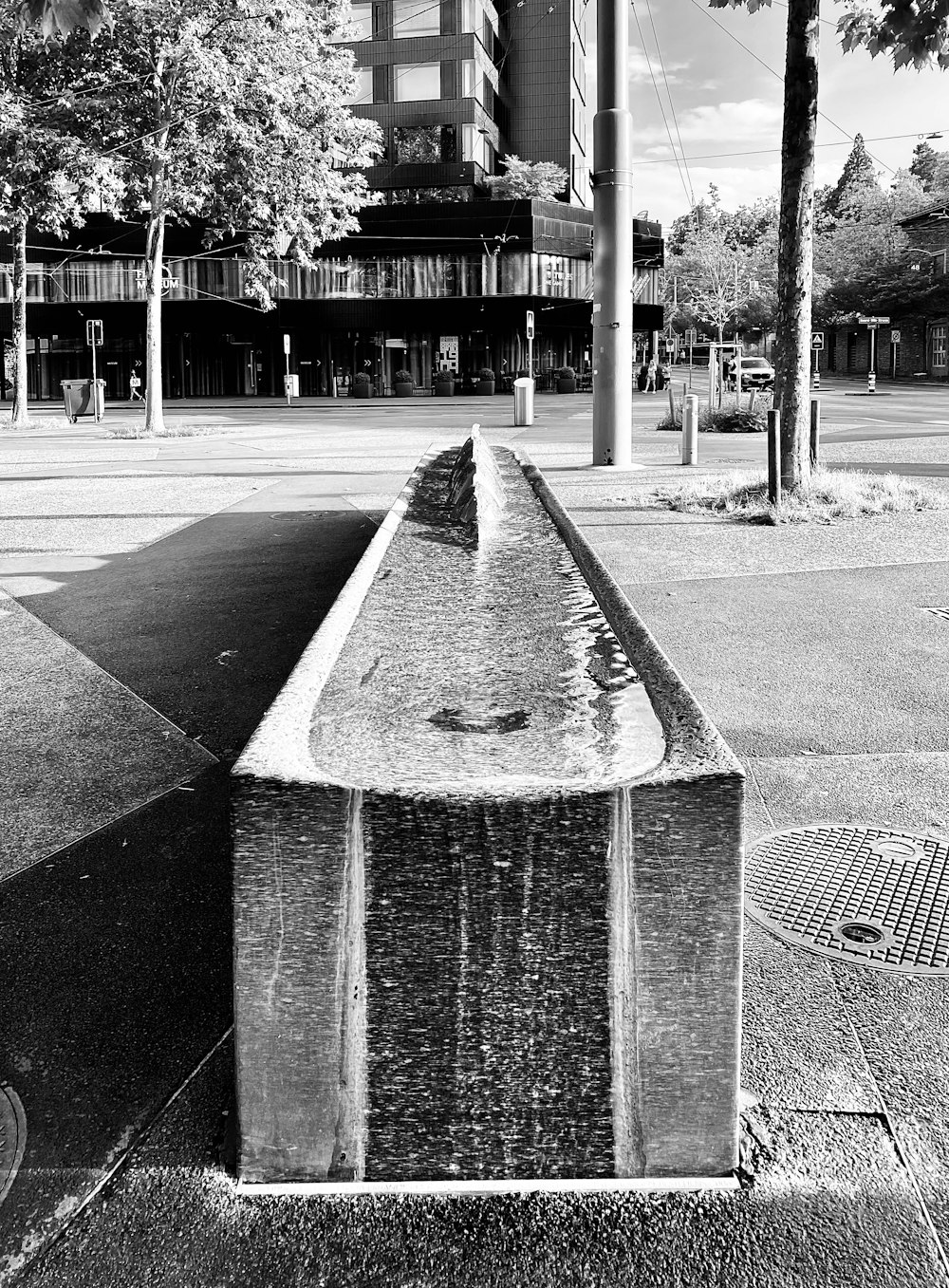 a black and white photo of a water fountain