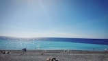 A stunning beach view with clear blue water and sunlight.