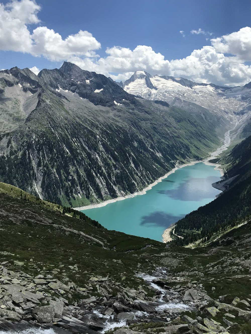 a view of a lake in the middle of a mountain range