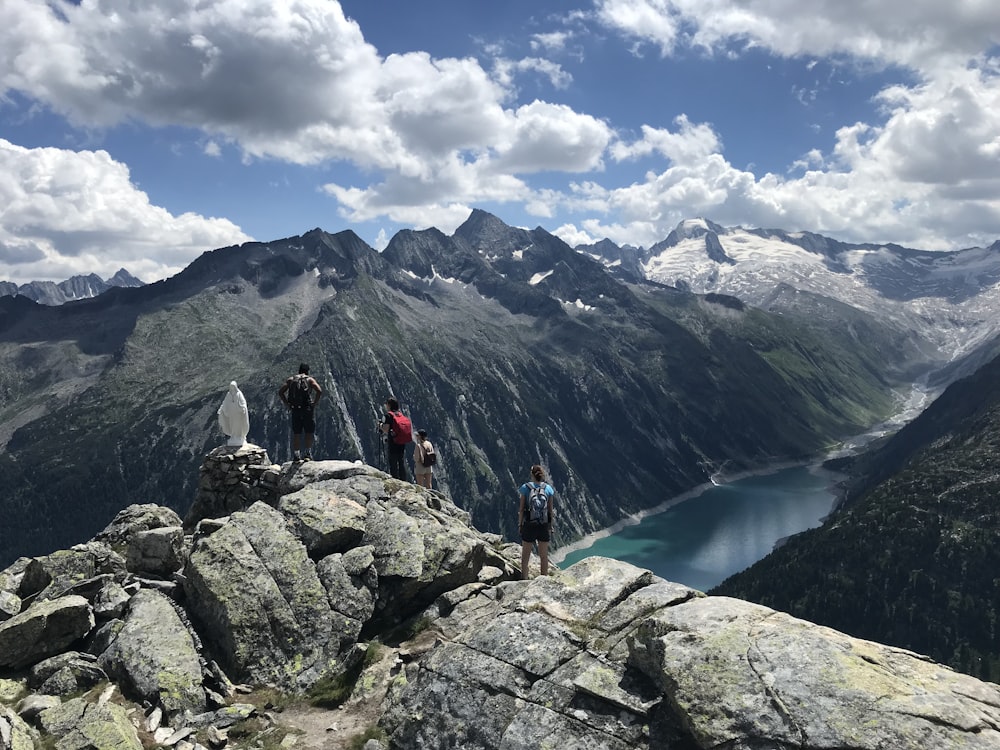 a group of people standing on top of a mountain