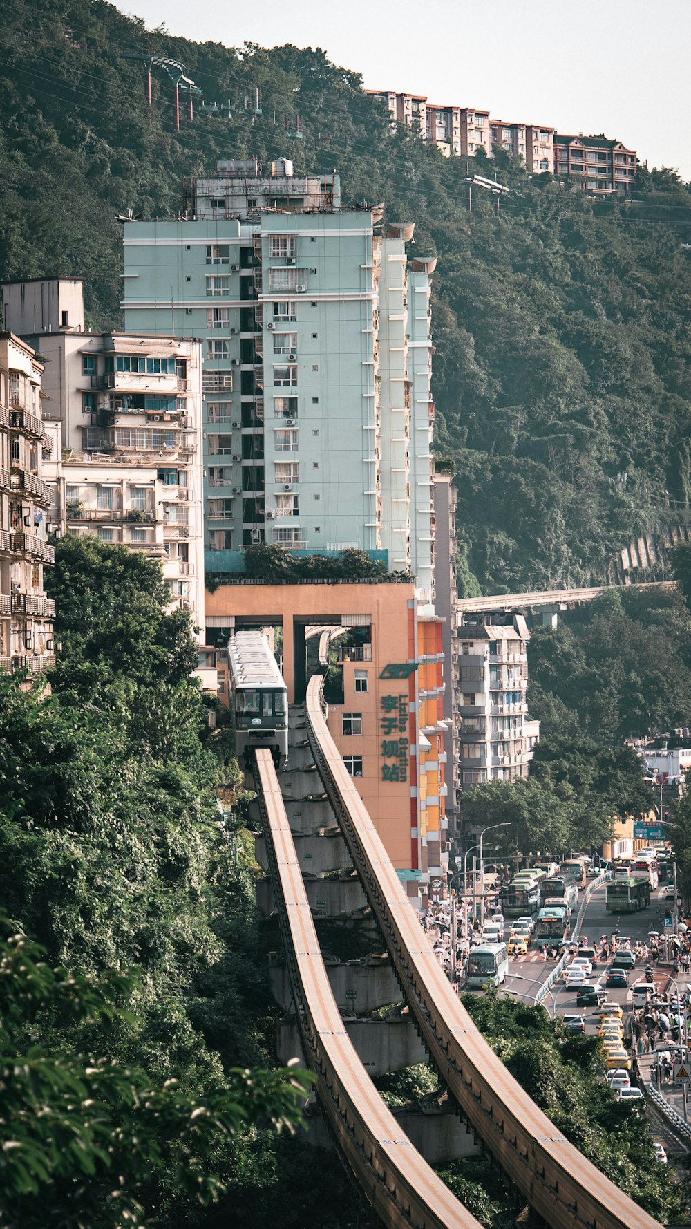 a very tall building next to a very steep hill