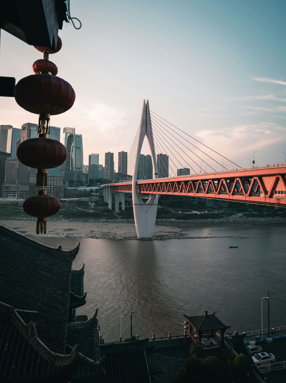 a bridge over a body of water with buildings in the background