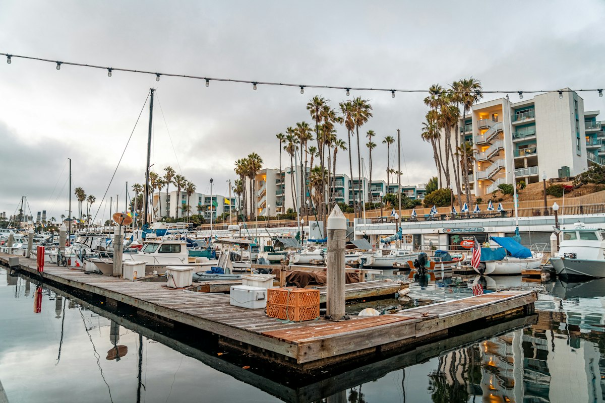 A marina filled with boats under a cloudy sky