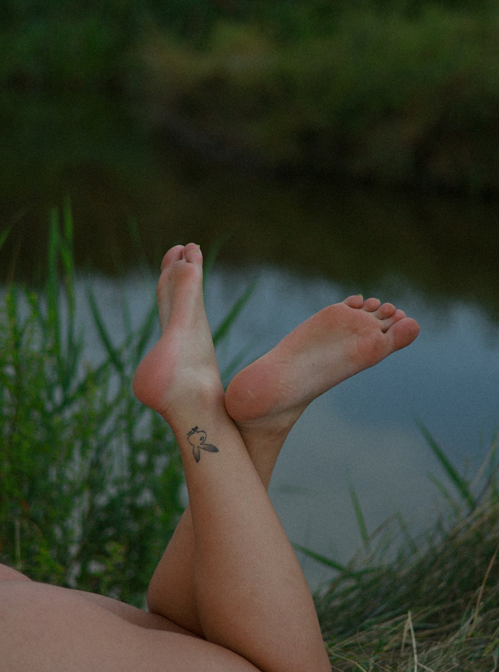 a person laying on the ground with their legs crossed