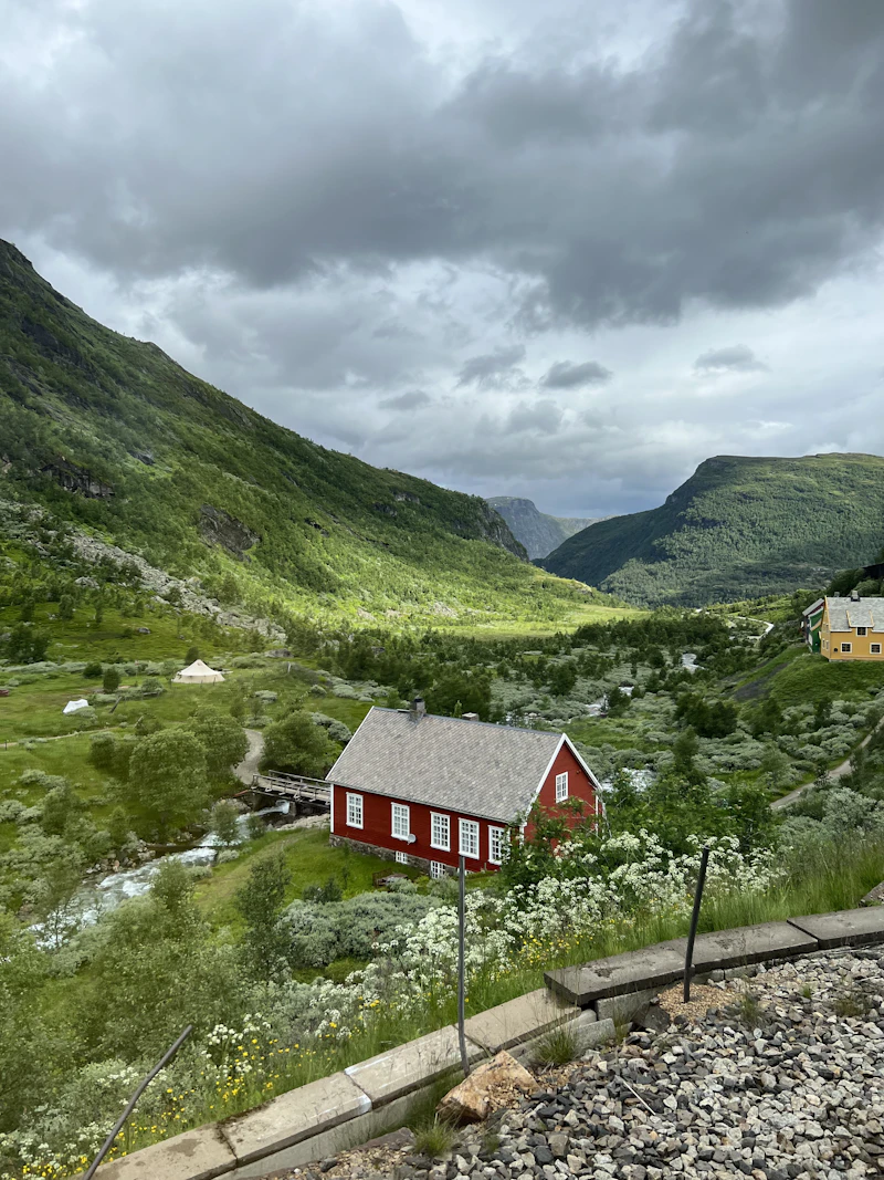 A red house on a green hillside