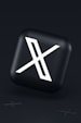 a black button with a white symbol on it