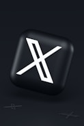 a black button with a white symbol on it