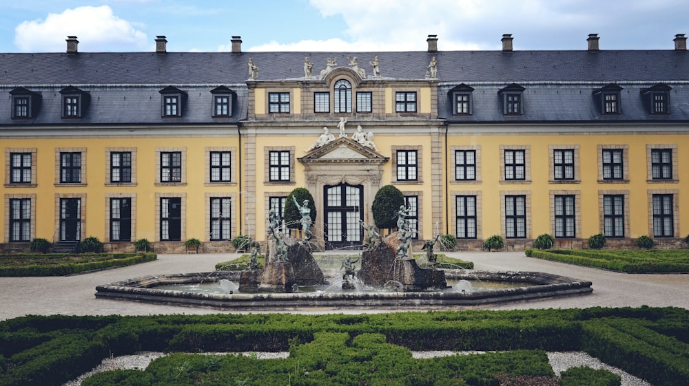 a large building with a fountain in front of it