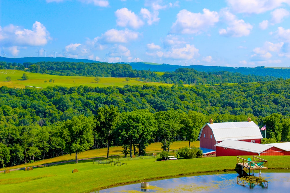 a farm with a pond in the middle of it