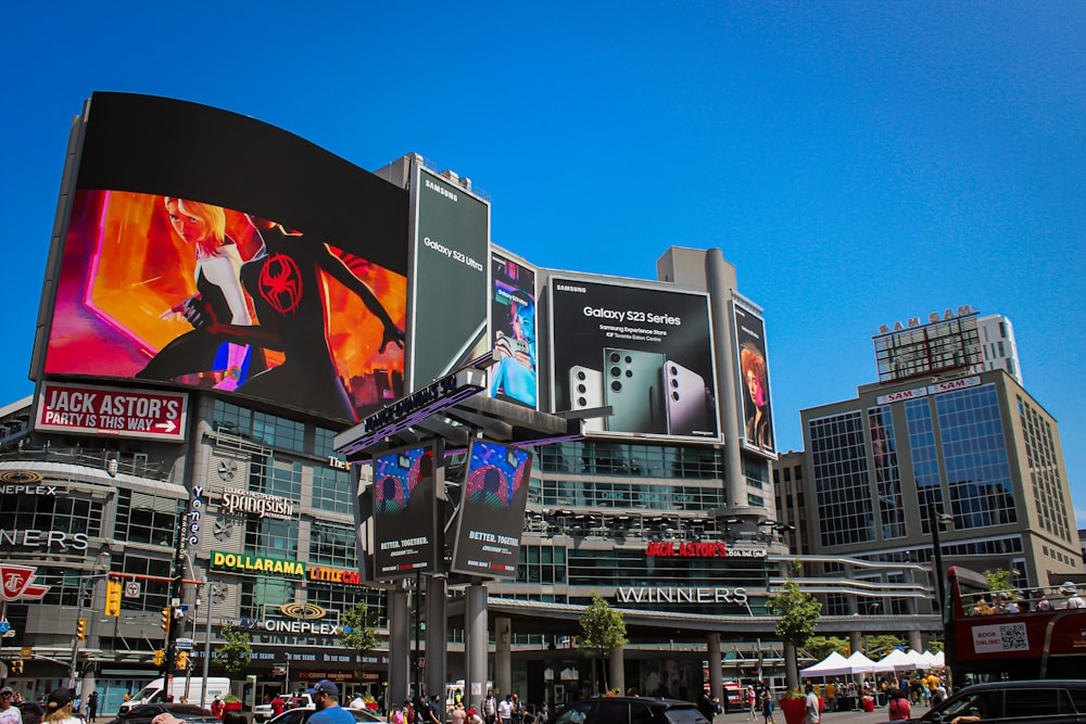 a busy city street with a large billboard on the side of it