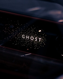 a close up of a car dashboard with the word ghost written on it