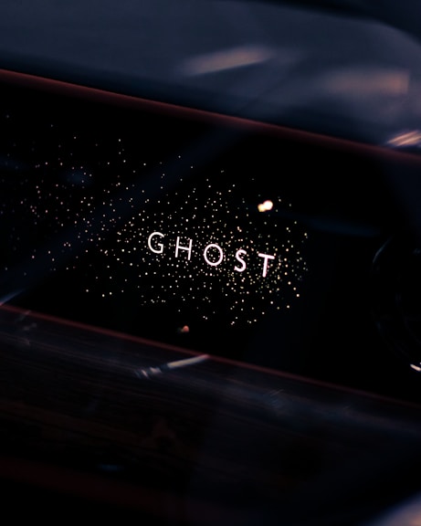 a close up of a car dashboard with the word ghost written on it