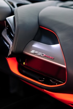 A close-up of a Ferrari F8 Tributo's cockpit, showcasing its luxurious racing controls.