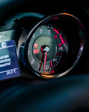 a close up of a car dashboard with a speedometer