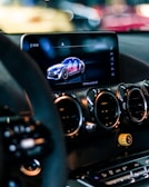 a car dashboard with a cell phone in the center