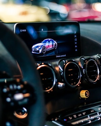 a car dashboard with a cell phone in the center
