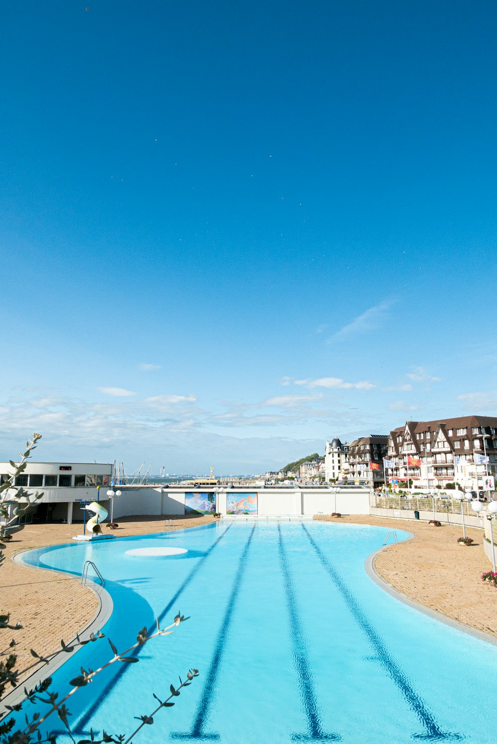 a large swimming pool in the middle of a beach