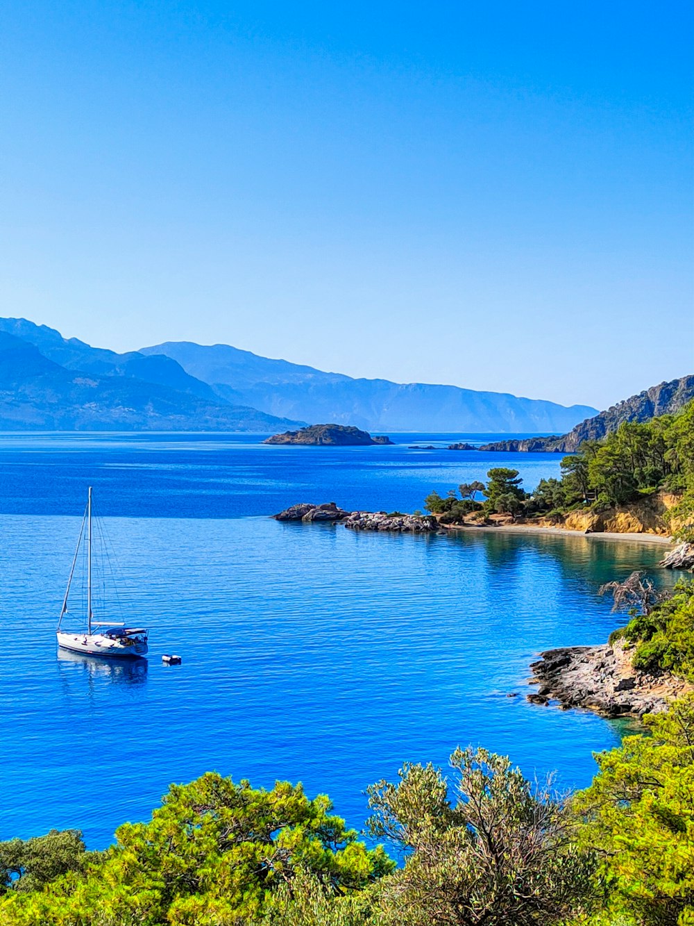 a sailboat floating on a large body of water