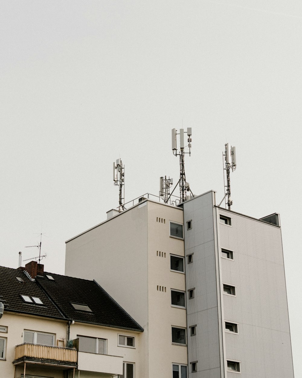 a tall white building sitting next to a tall white building