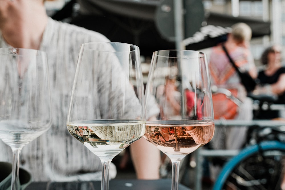 three glasses of wine are sitting on a table