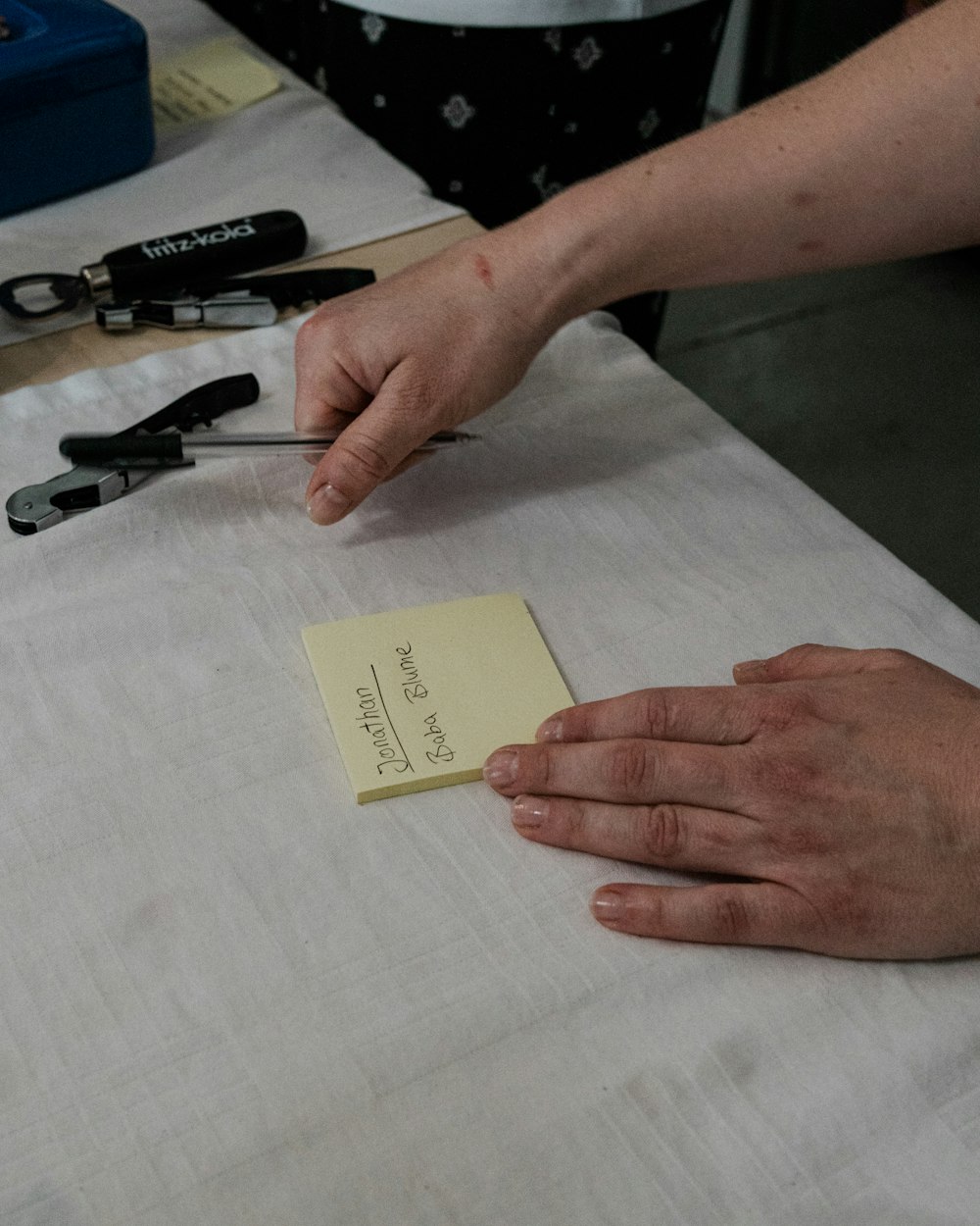 a person cutting a piece of paper with scissors
