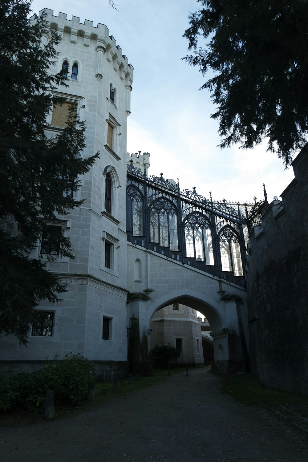 a large white building with a bridge in front of it