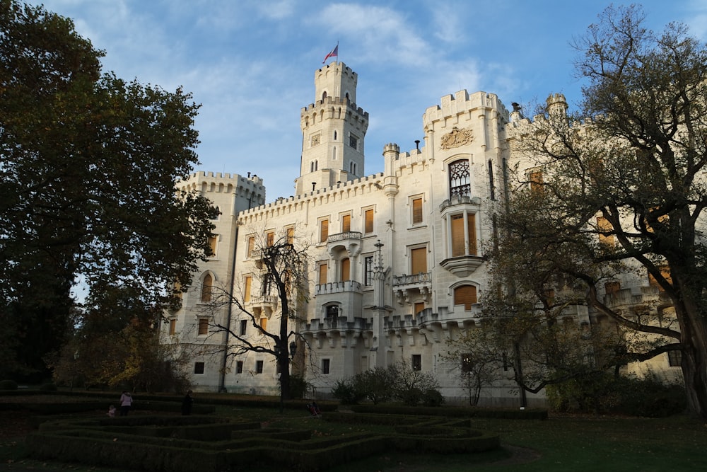 a large white castle with a clock tower