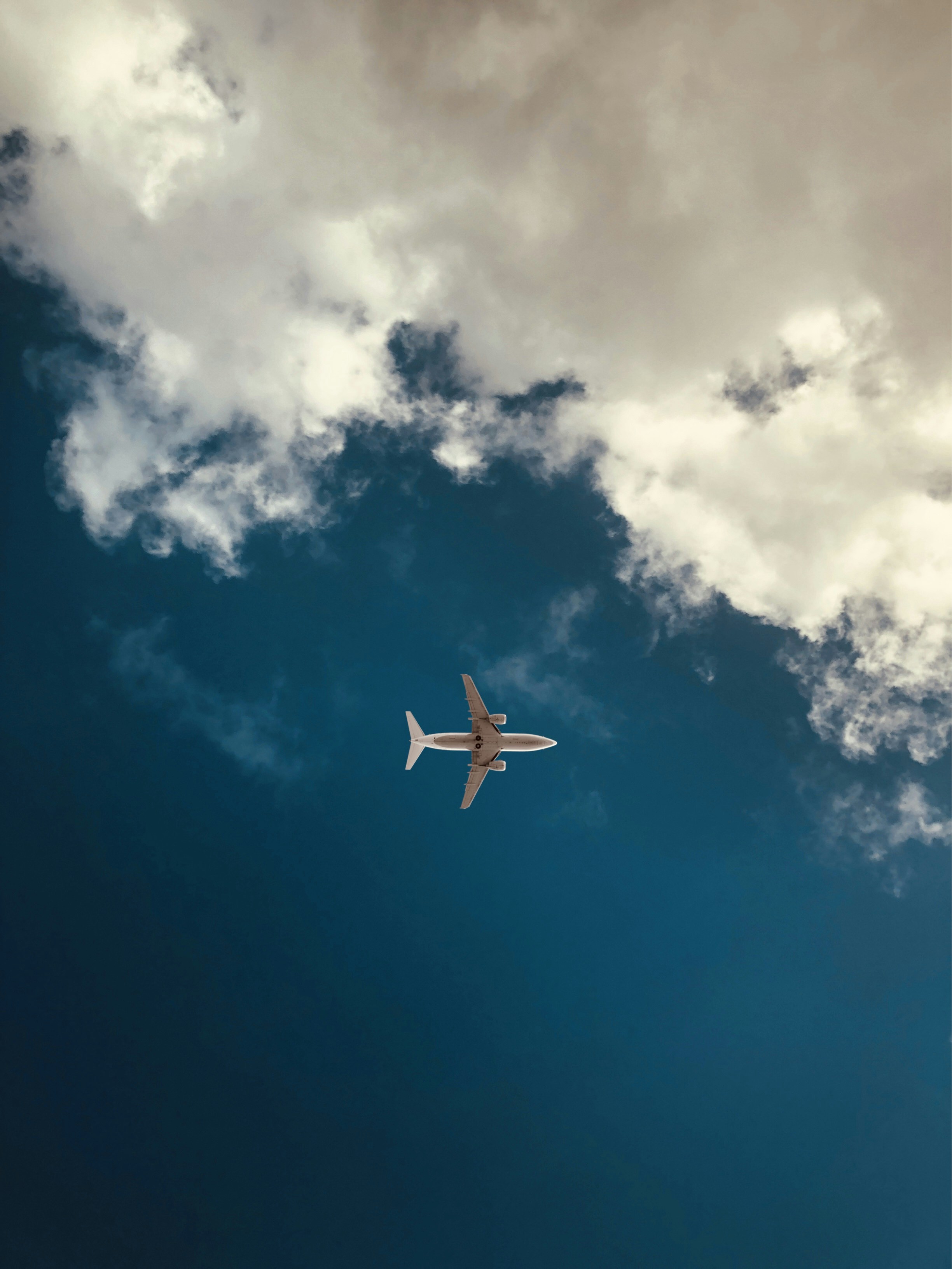 an airplane is flying in the sky with a lot of clouds