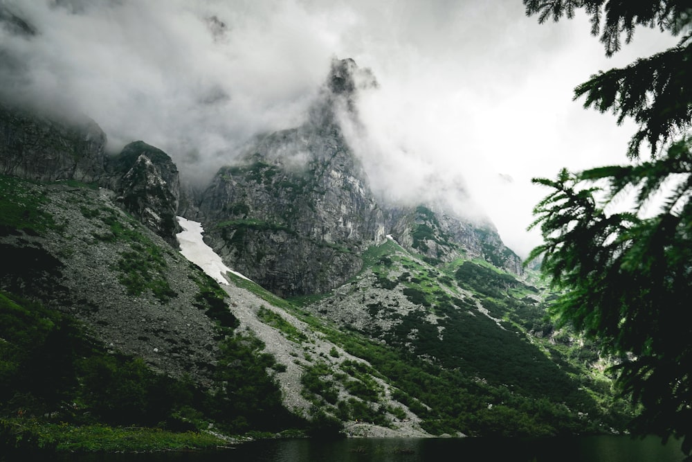 a mountain range with a lake in the foreground