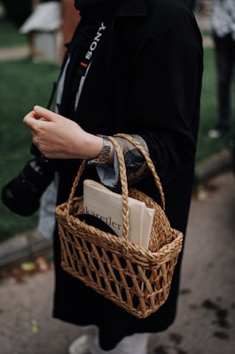 a person with a book in a wicker basket