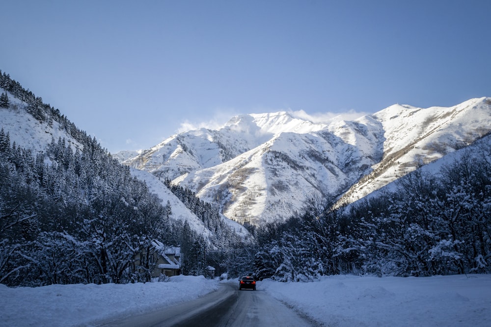 a car driving down a snow covered road