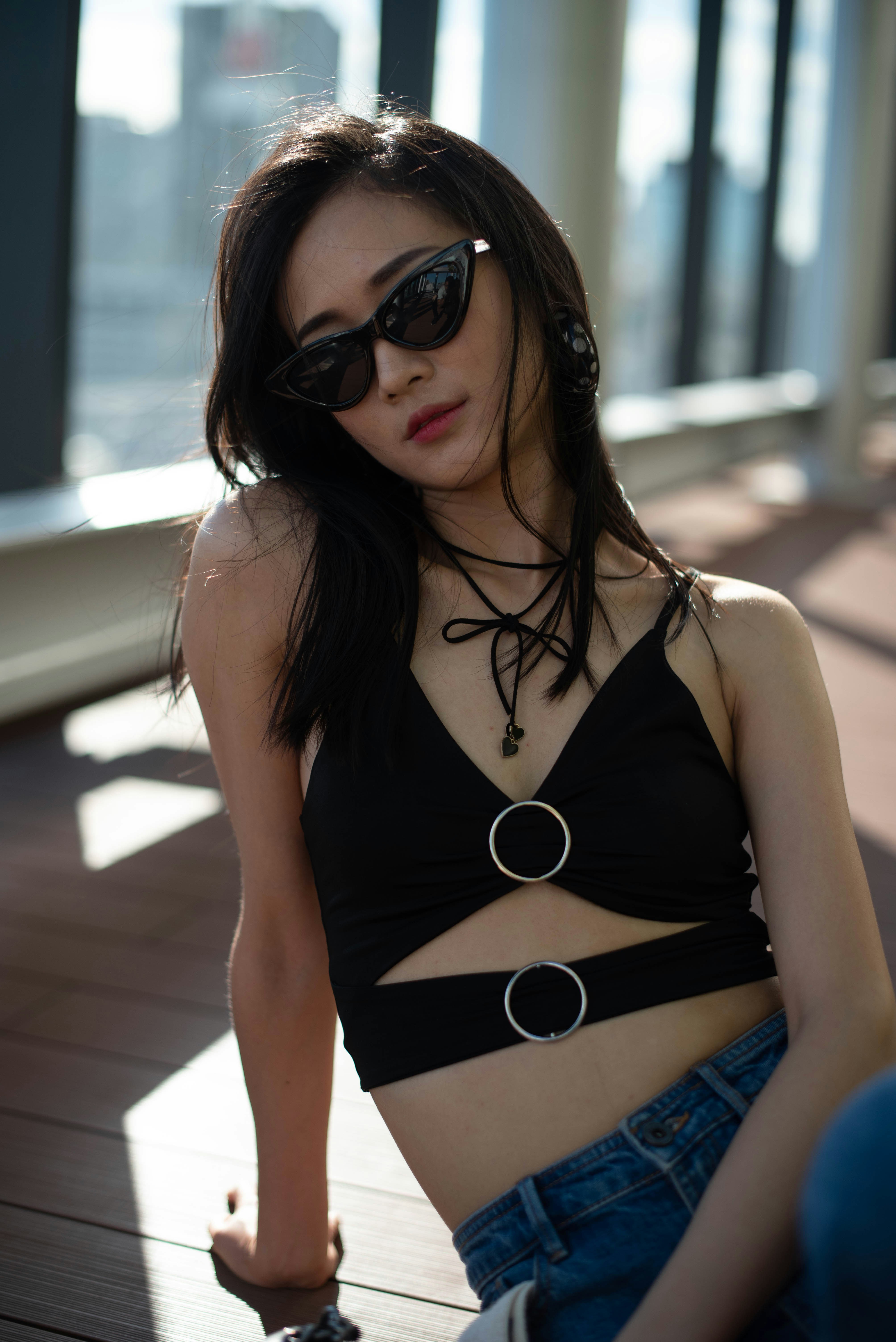 a woman wearing sunglasses and a black top