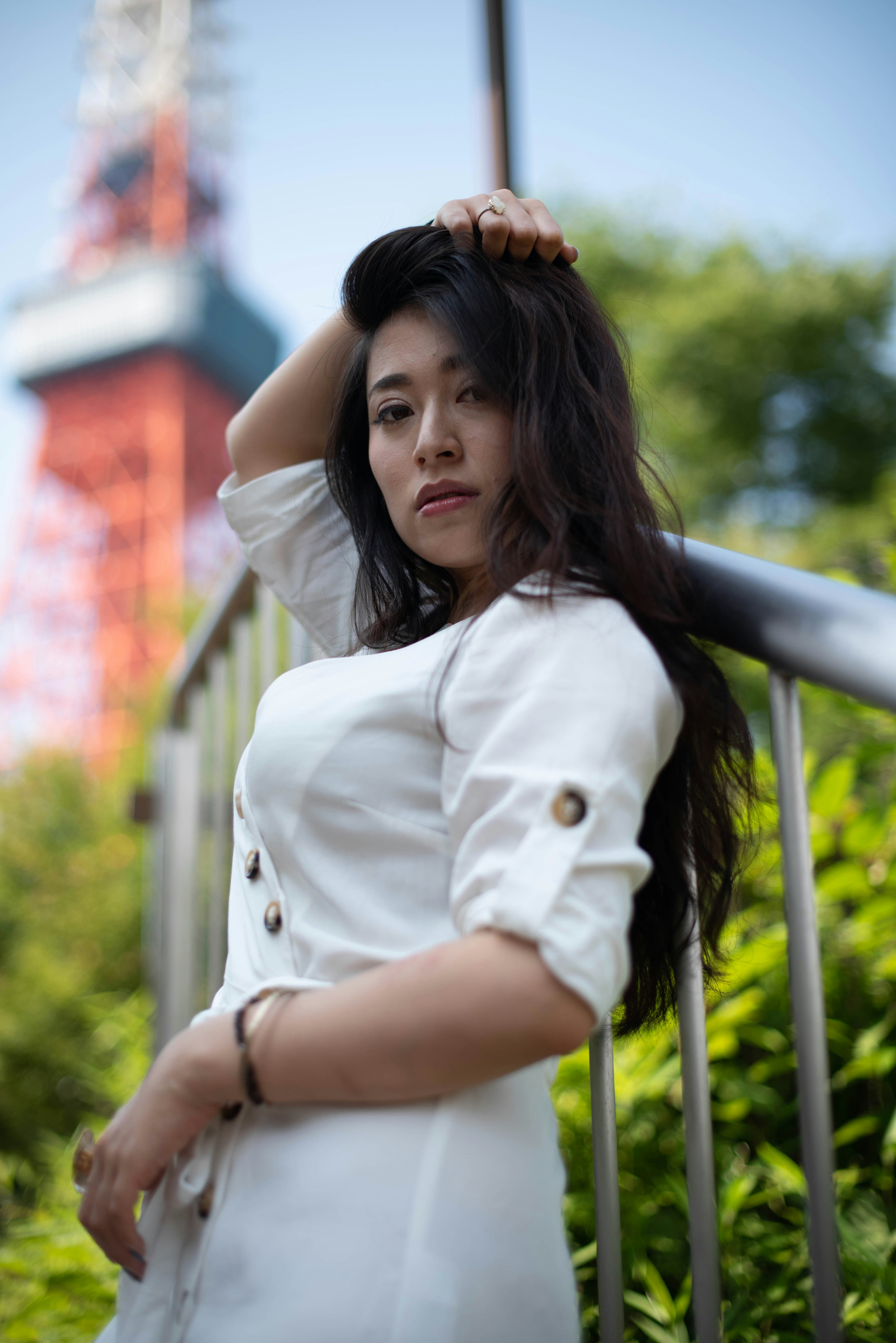 A woman in a white dress is posing for a picture photo – Free Woman ...