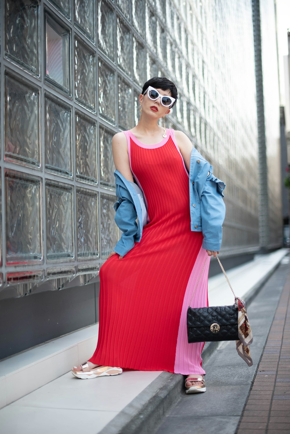 a woman in a red dress and a blue jacket