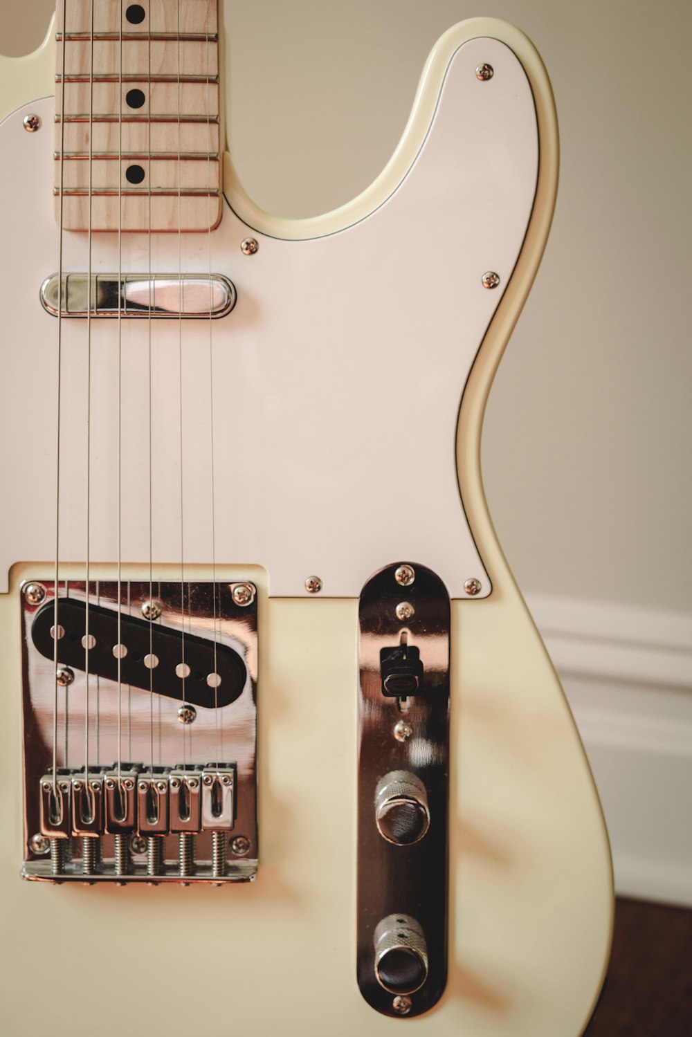 a close up of a white electric guitar